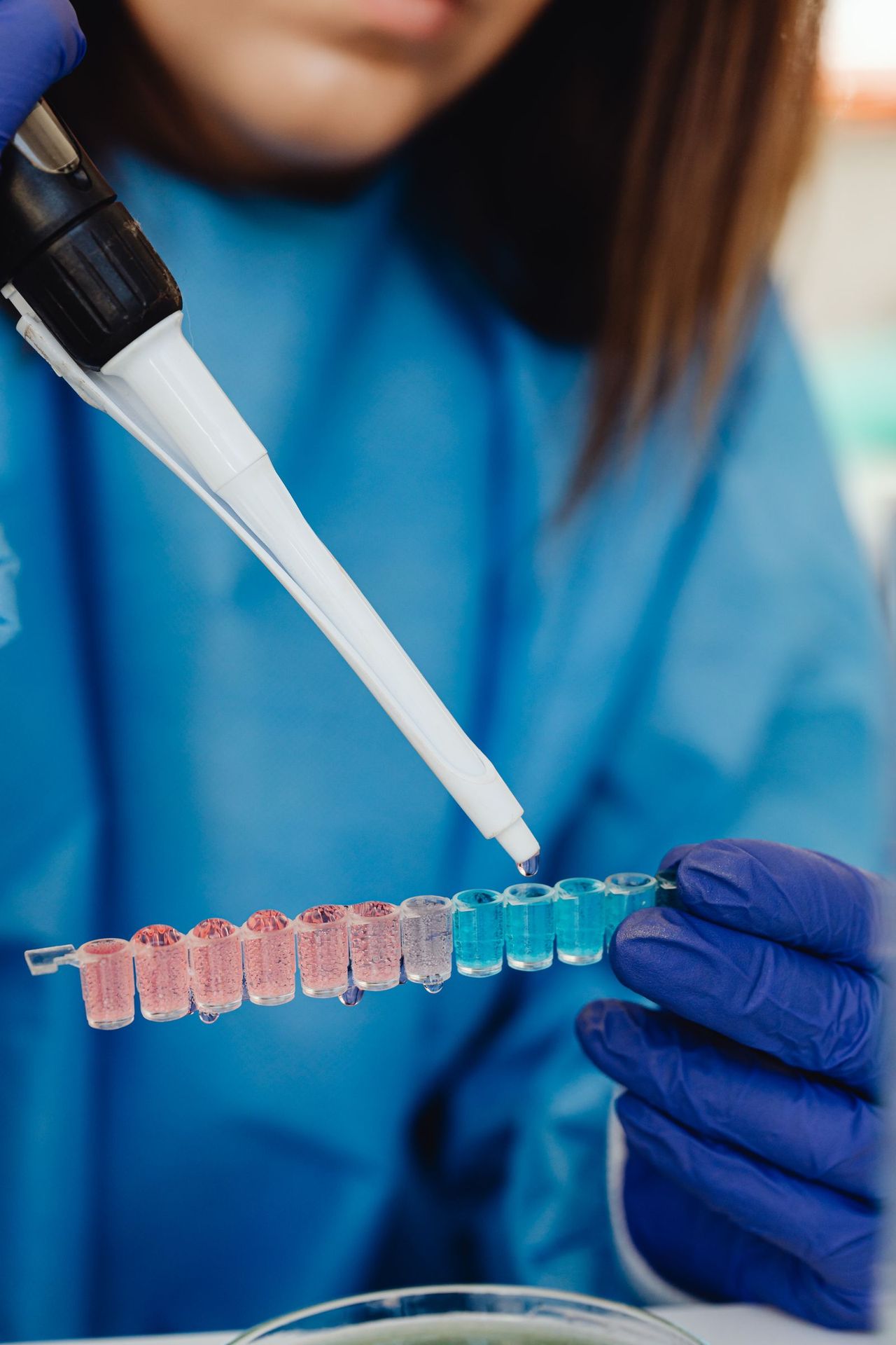 Laboratory professional using a pipette